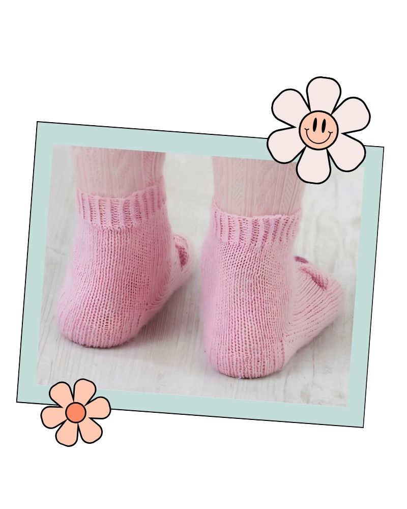 Back view of pink knitted socks showing the slip stitch heel flap and twisted rib cuff, Jane Burns sock pattern