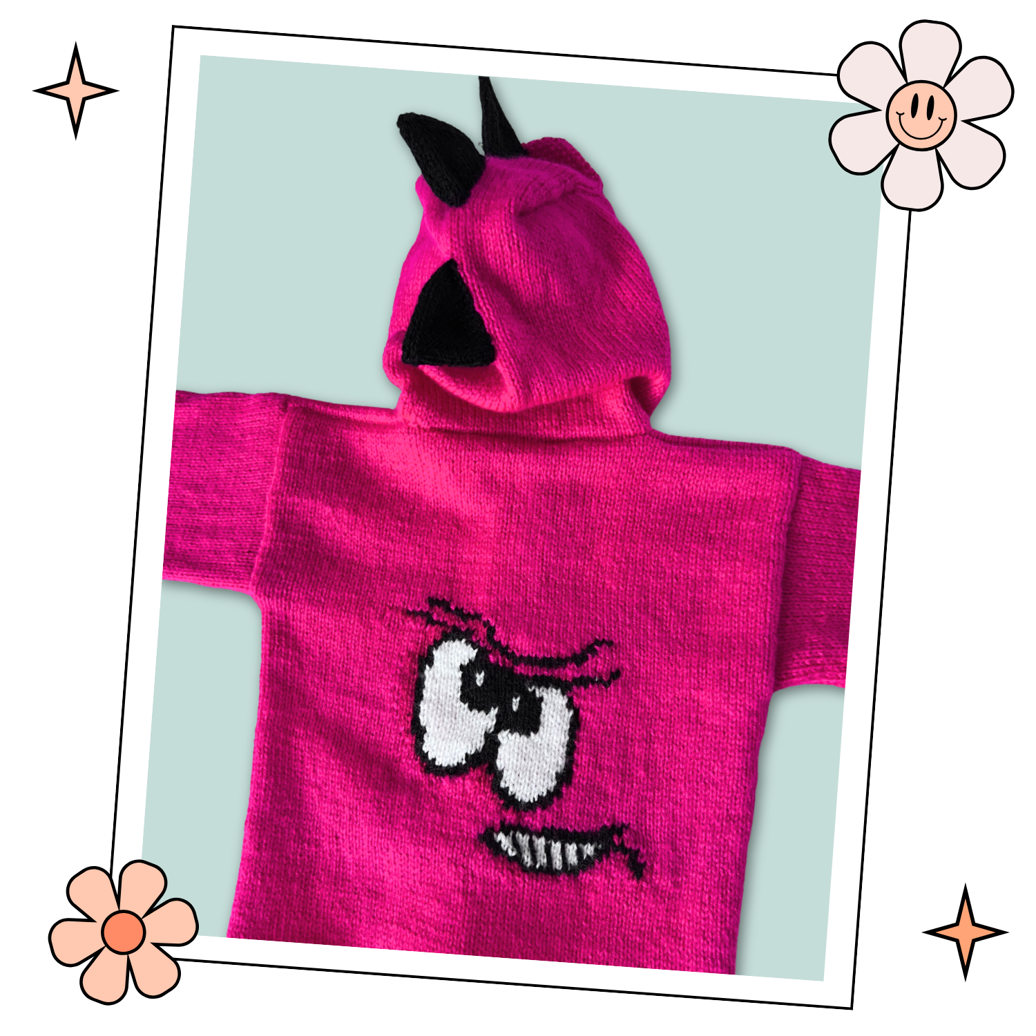 Pink knitted hoodie with cartoon face design on the back and black spikes on the hood, knitting pattern for kids hooded cardigan jane burns