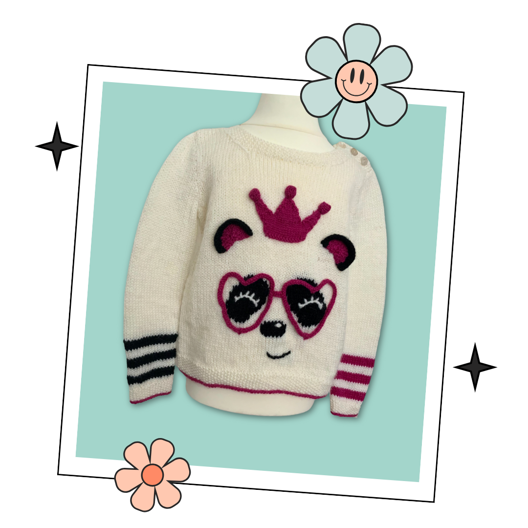 The perfect party ready pullover for the Panda loving Queen in your life.  Say hello to your little one’s new favourite jumper. Sized to fit ages 1-9 years please see table in image section for full yarn and sizing requirements.
The sweater is knit from the bottom up and seamed, there is a small chart included for the panda eyes and nose which you can either work using the intarsia method or duplicate stitch if you prefer. Lengths of i-cord are knitted and shaped to form those fabulous love heart glasses an