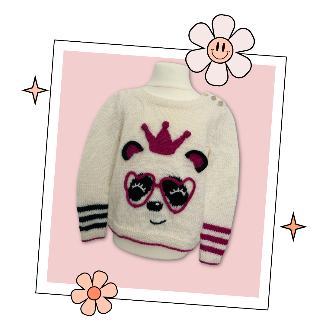 The perfect party ready pullover for the Panda loving Queen in your life.  Say hello to your little one’s new favourite jumper. Sized to fit ages 1-9 years please see table in image section for full yarn and sizing requirements.
The sweater is knit from the bottom up and seamed, there is a small chart included for the panda eyes and nose which you can either work using the intarsia method or duplicate stitch if you prefer. Lengths of i-cord are knitted and shaped to form those fabulous love heart glasses an