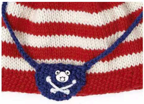 knitting pattern for baby hat and shorts set, pirate eye patch on the baby beanie hat and pirate flag motif on the baby knitted shorts, jane burns knitting pattern download