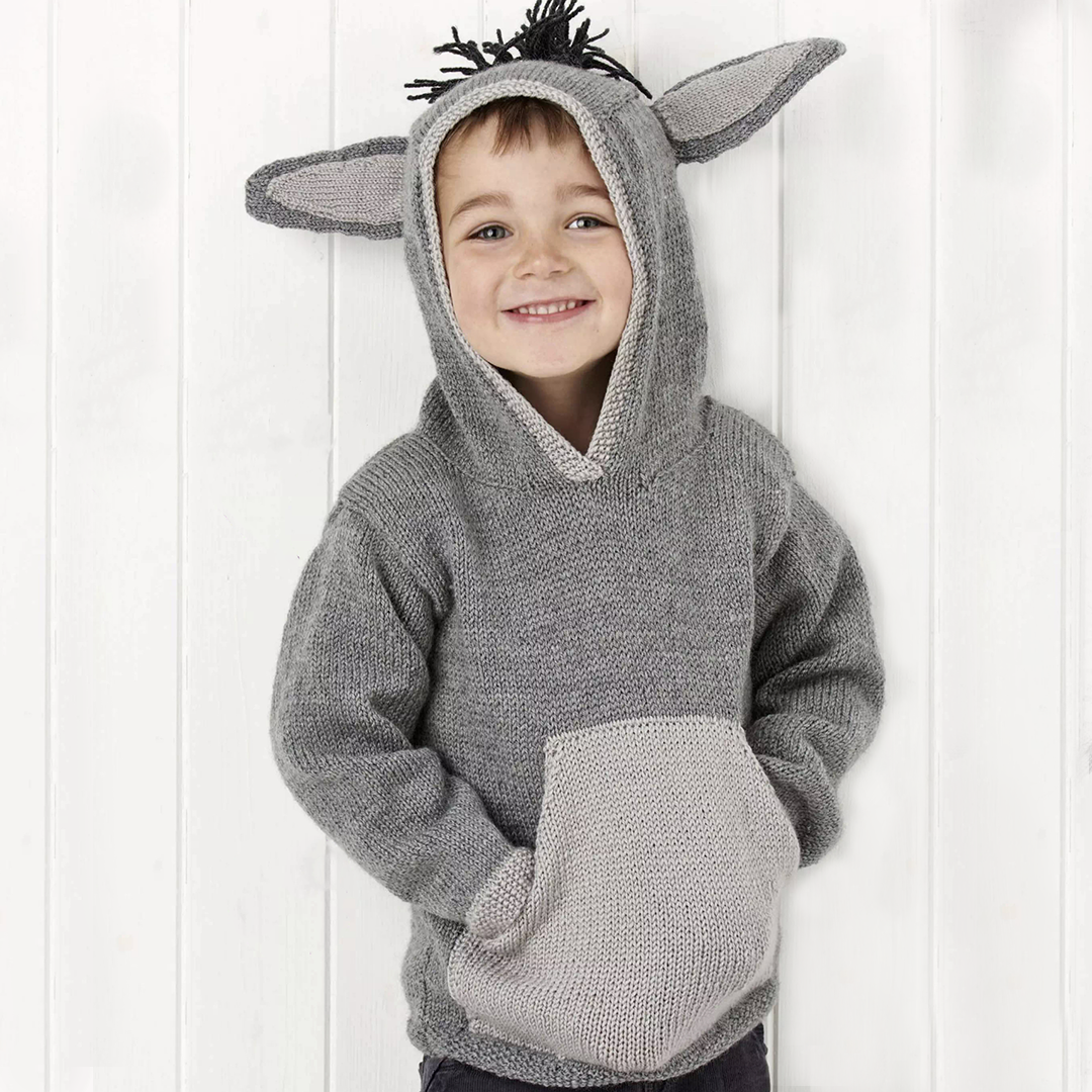 grey knitted hooded sweater with light grey kangaroo style pocket on the front, large donkey ears and a black mane create this cute donkey hoodie knitting pattern by jane burns