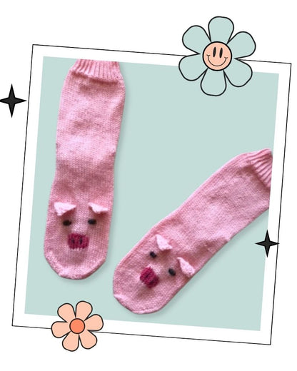 Pair of pink hand knitted pig socks laid flat, top down sock knitting pattern in child, teen and adult sizes