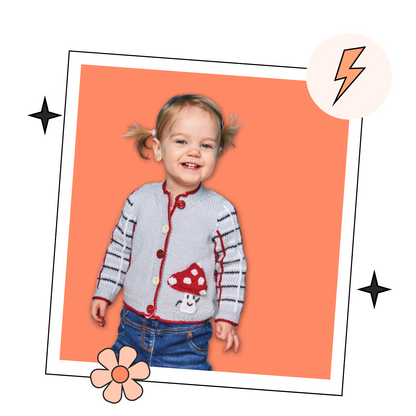 Child wearing a colorful cardigan with mushroom design on an orange background Knitted children's cardigan with red trim and mushroom design on a white background, Fun guy Mushroom cardigan knitted pattern for babies with plaid sleeves. jane burns designs