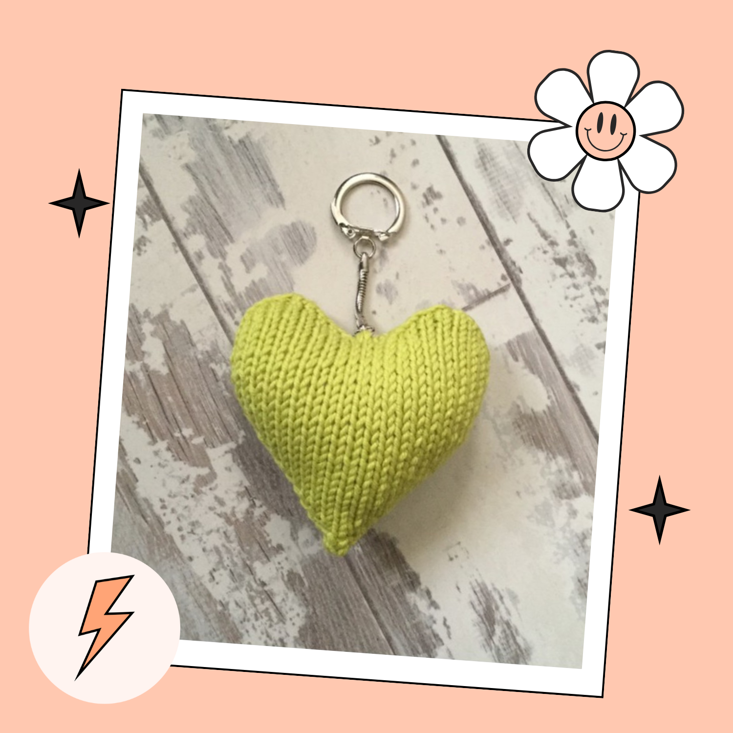 Yellow knitted heart keychain on a wooden surface with decorative elements. Valentines knitted heart keyring pattern jane burns