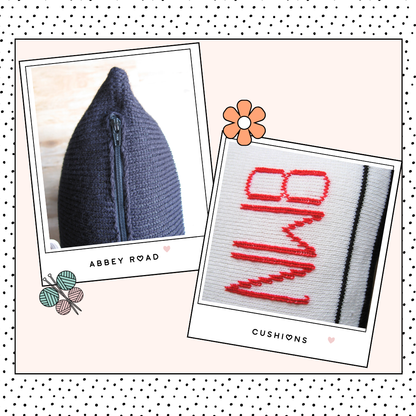 Image shows two knitted cushions one showing the abbey road street sign and behind it a second black and white striped cushion looking like the zebra crossing from the beatles music album knitting pattern by jane burns