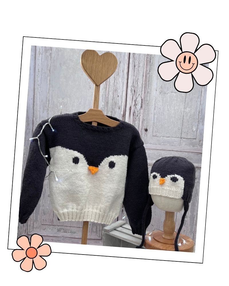 Baby penguin jumper and matching aviator hat on display stands, DK knitting pattern for 0 months to 5 years