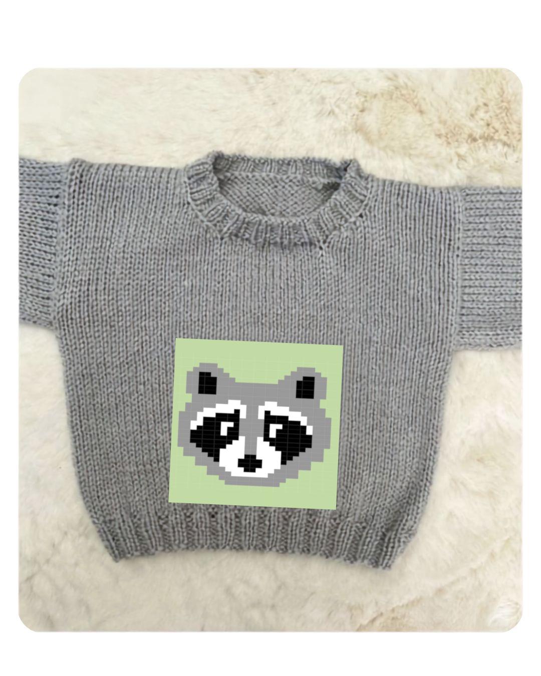 Raccoon jumper knitted for a baby, Bandit motif on the Blank Canvas Baby Sweater in Meadow green