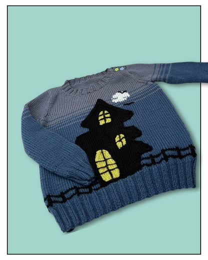 A blue and gray striped knit sweater featuring a large black haunted house with yellow glowing windows on the front, displayed on a solid mint green background.