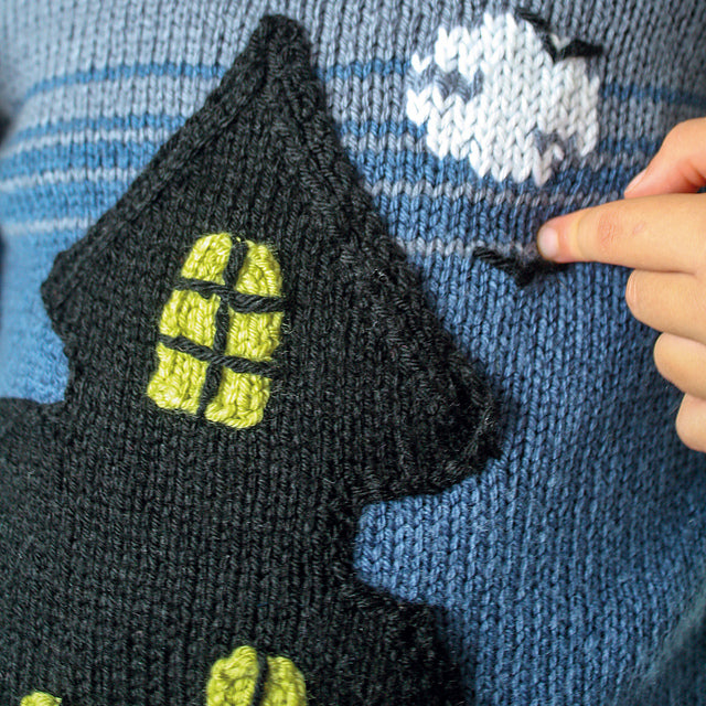 knitting pattern for a blue kids jumper, large black spooky ghost house on the front which has pockets, ghost mittens for child, dk yarn, kids sweater knitting pattern, spooky, halloween, halloween jumper