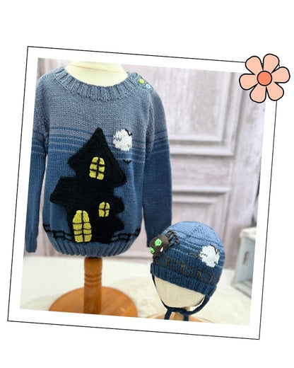 Ghost house jumper and spider halloween hat knitting patterns by Jane Burns.
A blue knit children's sweater and matching beanie displayed on mannequin heads. The sweater features a black house with yellow window details and white cloud motifs, while the matching hat includes a spider and cloud applique.