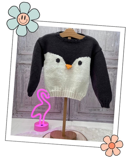 Knitted penguin jumper with black eyes and orange beak, simple intarsia knitting pattern for babies and toddlers