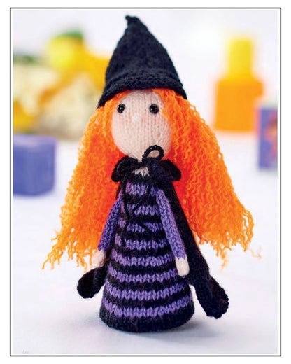 Monica the Witch knitted toy in black and purple DK yarn with orange hair, standing approximately 23cm tall