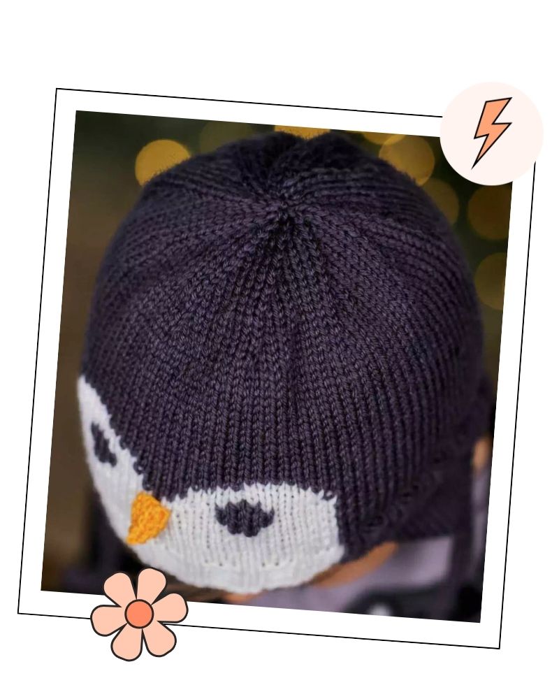 Crown of a knitted penguin hat showing the shaping and penguin face, aviator hat knitting pattern