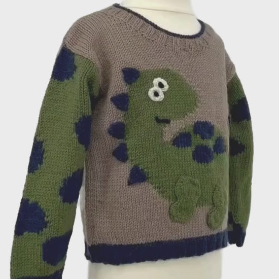 Dinosaur jumper knitting pattern, kids sweater with Dino motif and animal print sleeves. Intarsia knitting pattern for children’s jumper. Jane Burns Designs