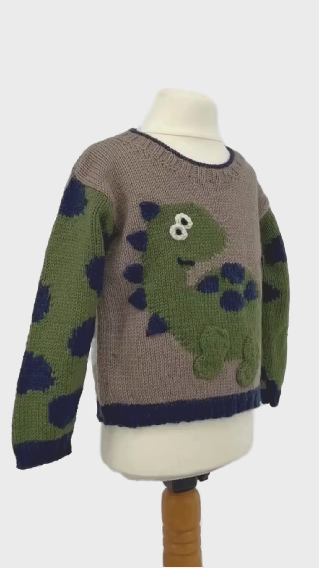 Dinosaur jumper knitting pattern, kids sweater with Dino motif and animal print sleeves. Intarsia knitting pattern for children’s jumper. Jane Burns Designs