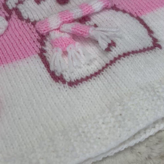 Girls pink Christmas jumper knitting pattern with an intarsia snowman in a bobble hat and stripy scarf, sizes 2 to 11