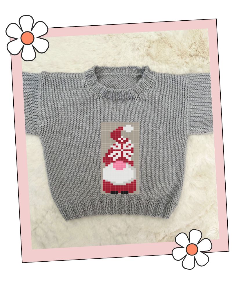 A gray knit crewneck sweater featuring a pixelated Christmas gnome design on the chest, displayed on a white faux fur background with a pink decorative border.