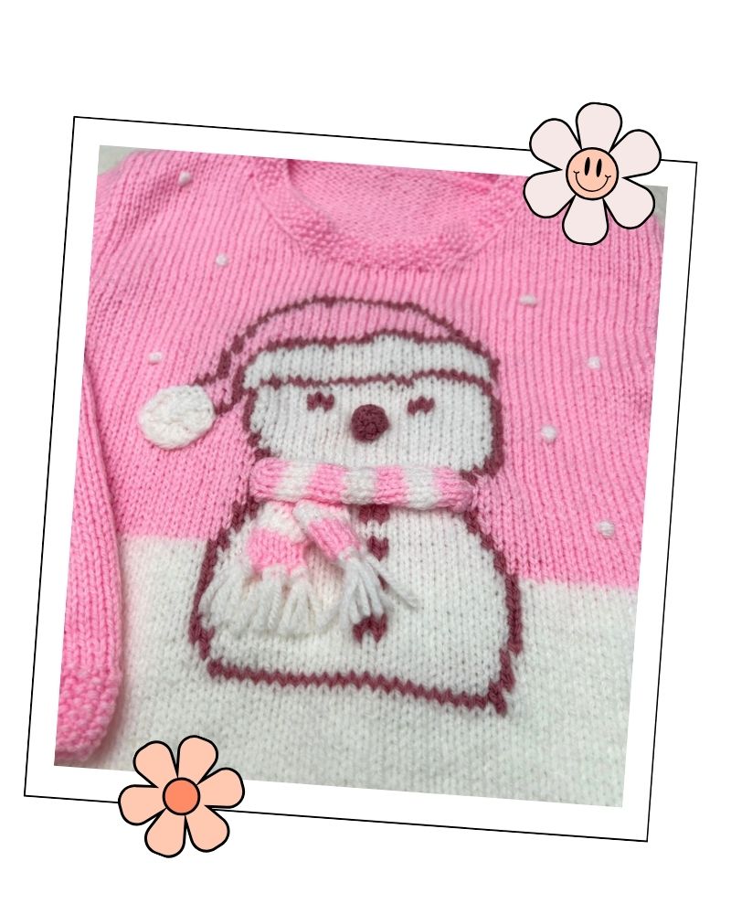Girls pink Christmas jumper knitting pattern with an intarsia snowman in a bobble hat and stripy scarf, sizes 2 to 11