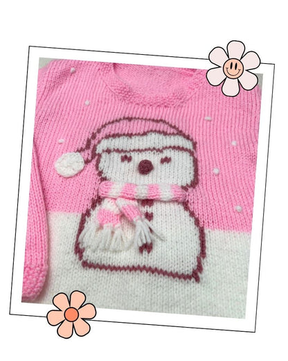 Girls pink Christmas jumper knitting pattern with an intarsia snowman in a bobble hat and stripy scarf, sizes 2 to 11