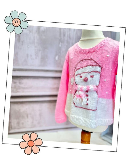 Pink snowman jumper for girls on a dress form, DK knitting pattern with a charted snowman and 3D details