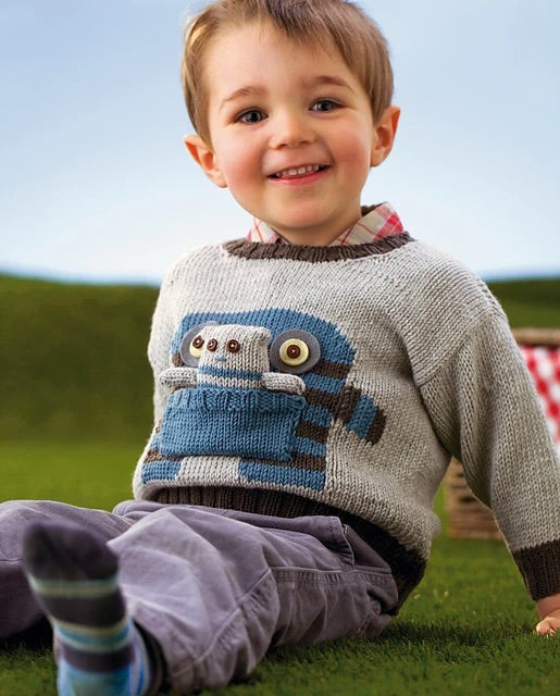 monster motif jumper with large pocket mouth and matching monster toy knitting pattern jane burns