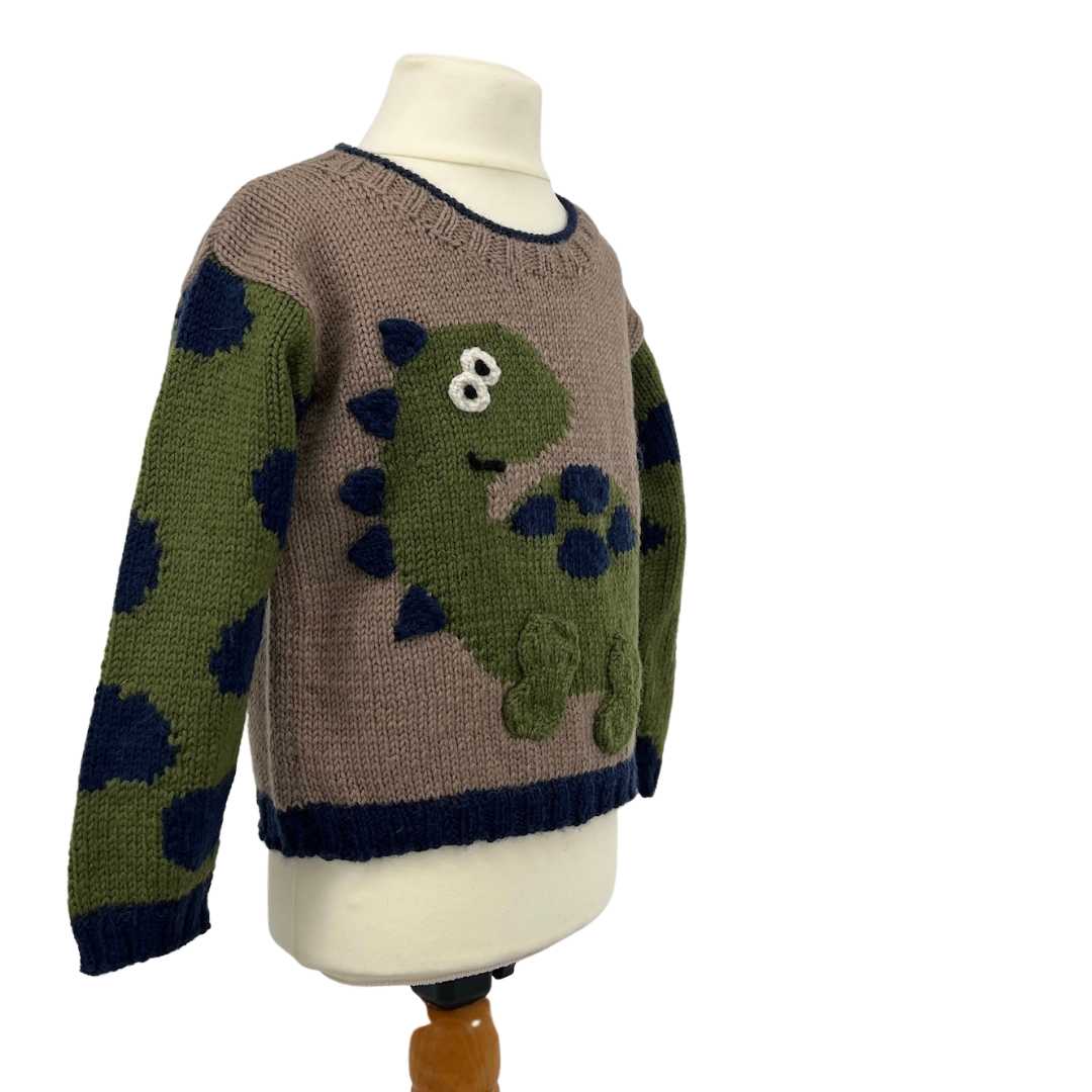 Dinosaur jumper knitting pattern, kids sweater with Dino motif and animal print sleeves. Intarsia knitting pattern for children’s jumper. Jane Burns Designs