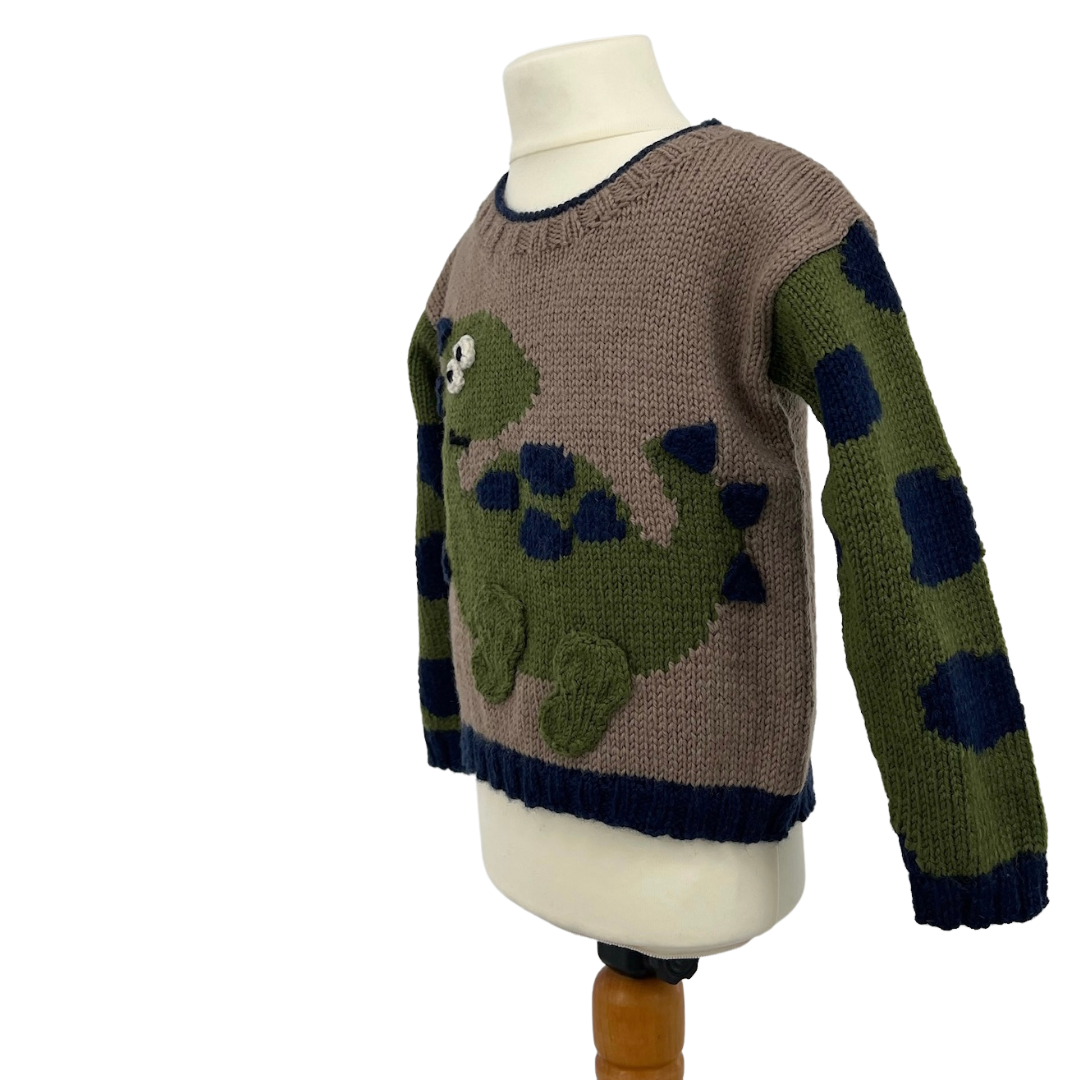 Dinosaur jumper knitting pattern, kids sweater with Dino motif and animal print sleeves. Intarsia knitting pattern for children’s jumper. Jane Burns Designs