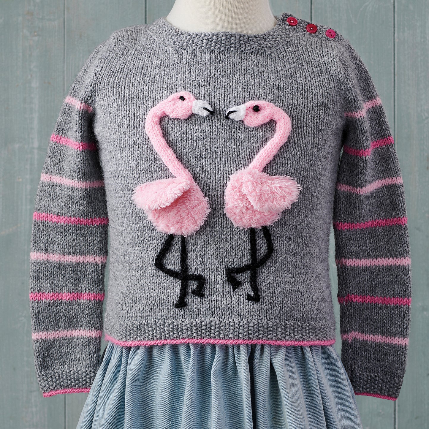 beige jumper with pastel stripes around cuff. fluffy llama head with applique ears and roses form this sleepy llama sweater pattern, jumper jane burns, intarsia