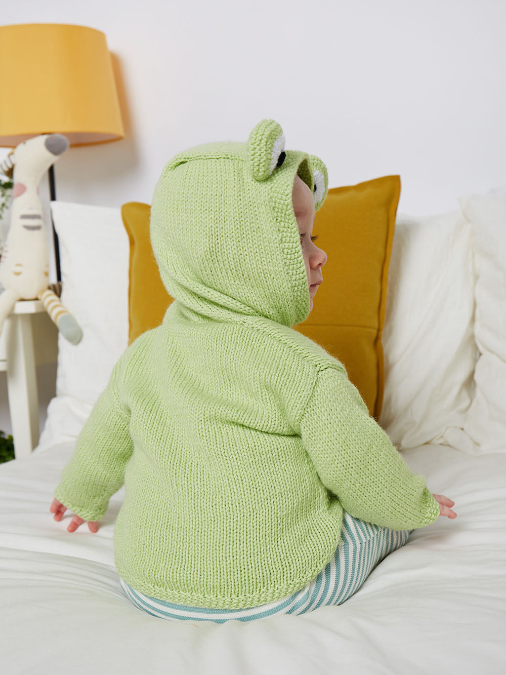 Simple hooded baby cardigan with large frog eyes on the hood. Easy construction, green hoodie knitting pattern jane burns